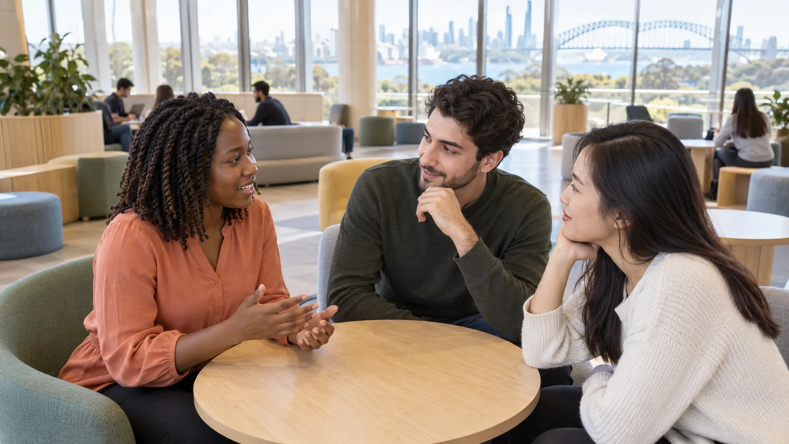 International graduates discuss post-study work opportunities in an Australian campus lounge.